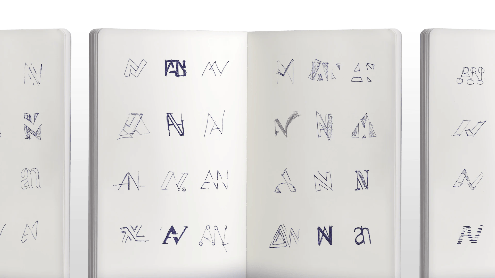 Open sketchbook displaying various logo designs with creative "A" and "N" letter styles.