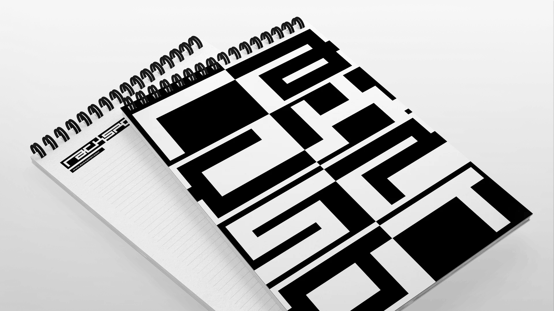 Black and white spiral notebook featuring bold geometric cover and clean, lined pages inside.