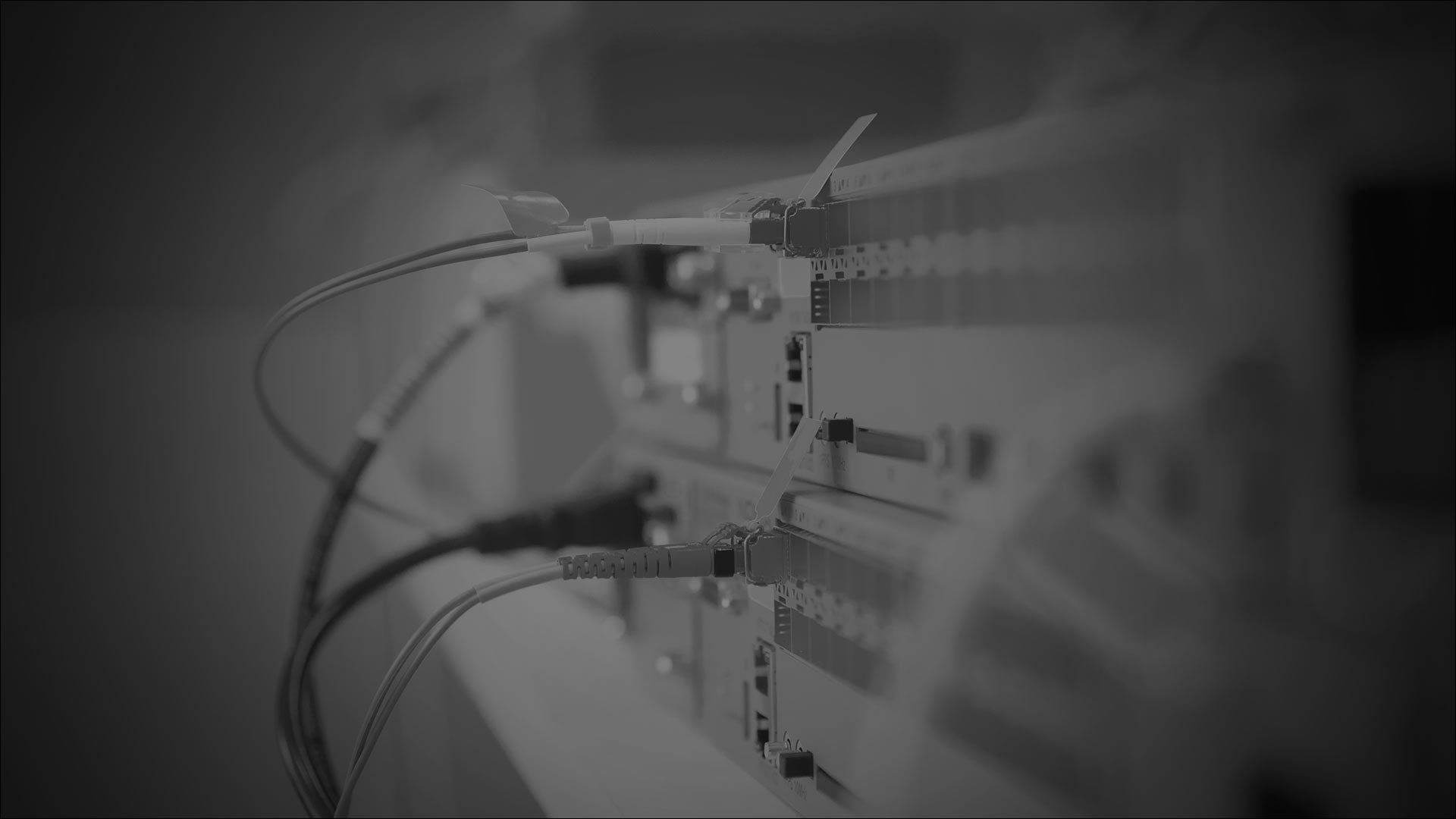 Photo of a computer surrounded by tangled wires, highlighting a vintage technology aesthetic.