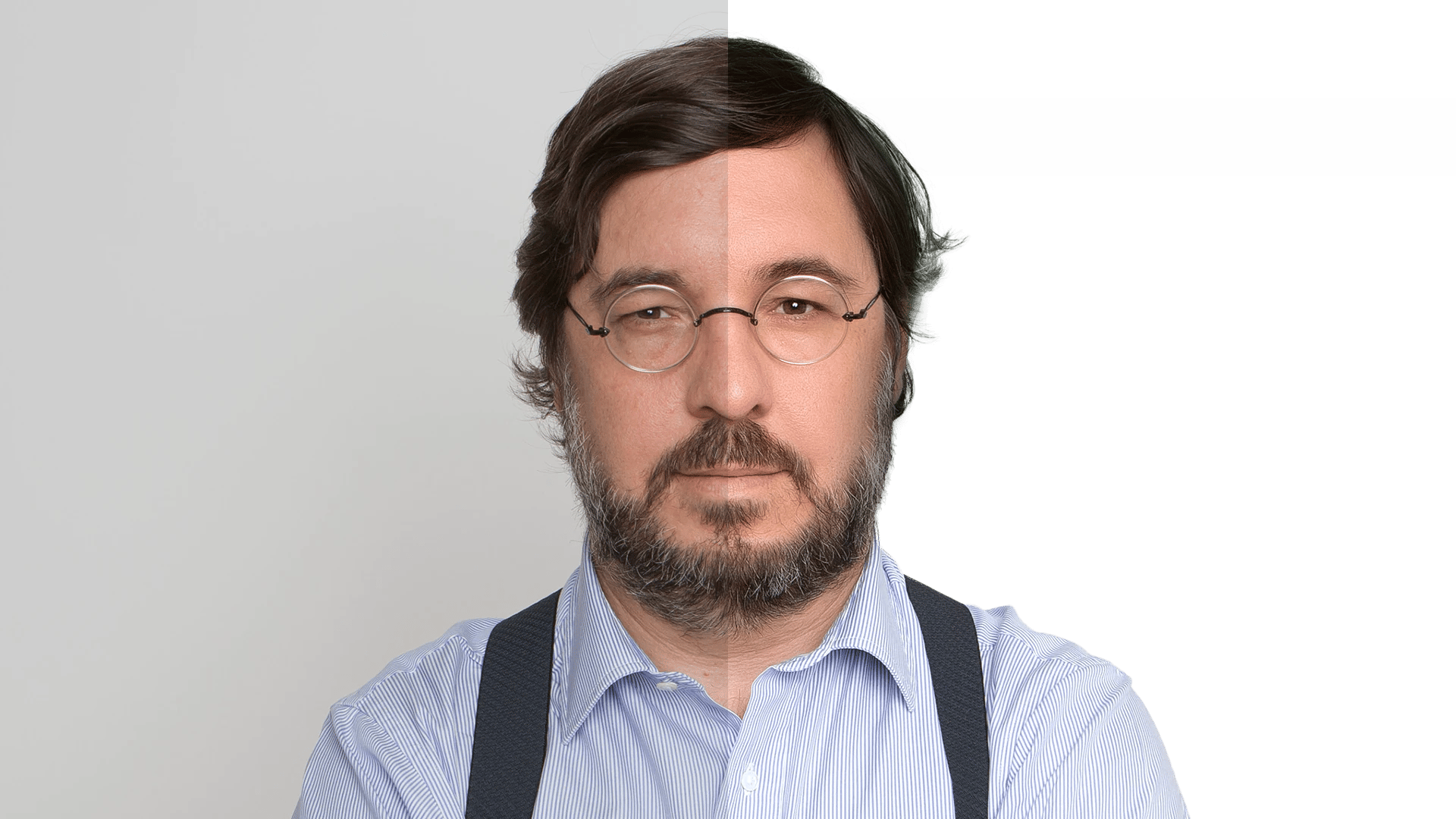 António Costa in stripes and suspenders, arms crossed, on a high-contrast background.