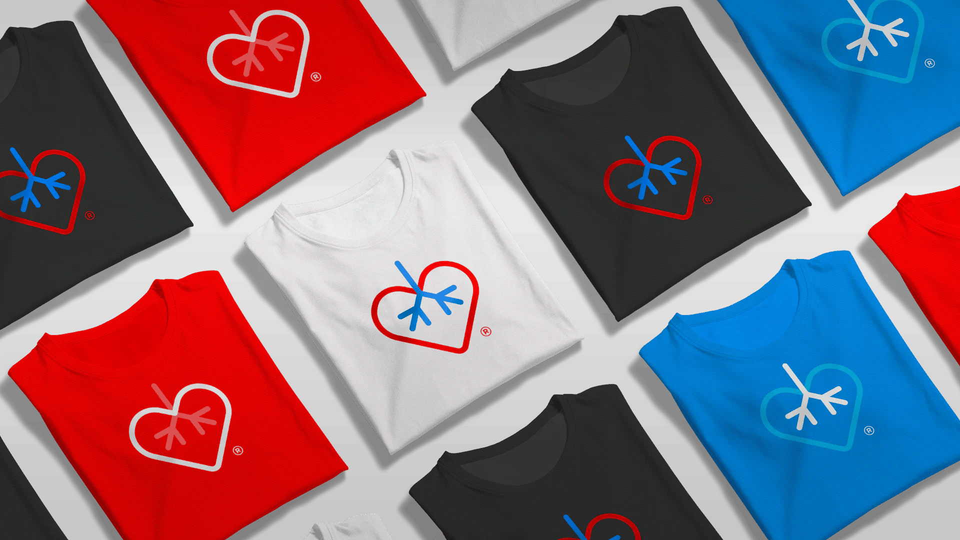 Colorful t-shirts in red, black, blue, and white with heart and snowflake logo designs.